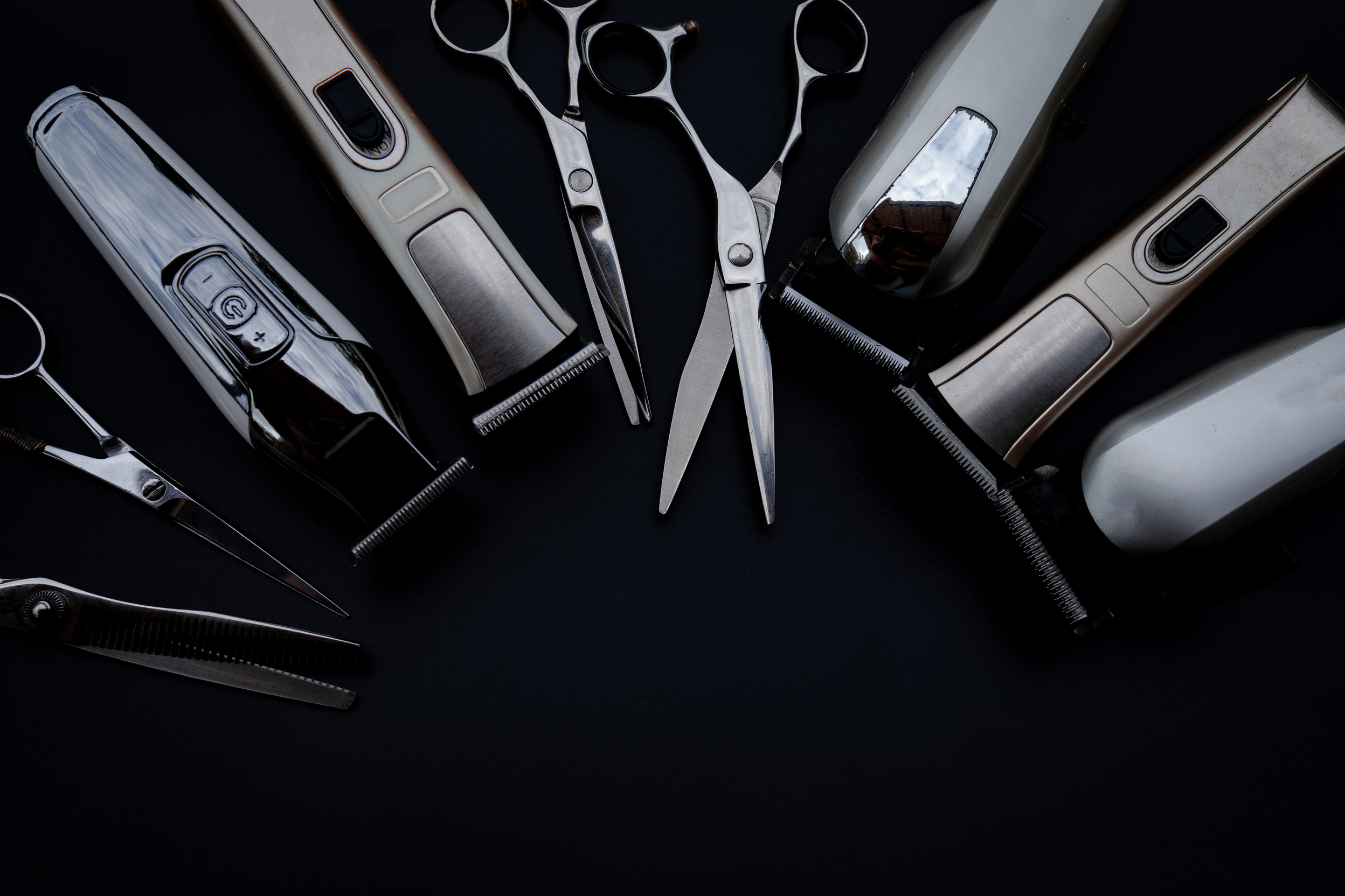 A Set of Hair Cut Tools on Black Background